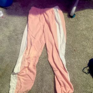 Pink/white sweatpants, scrunched at the ankle